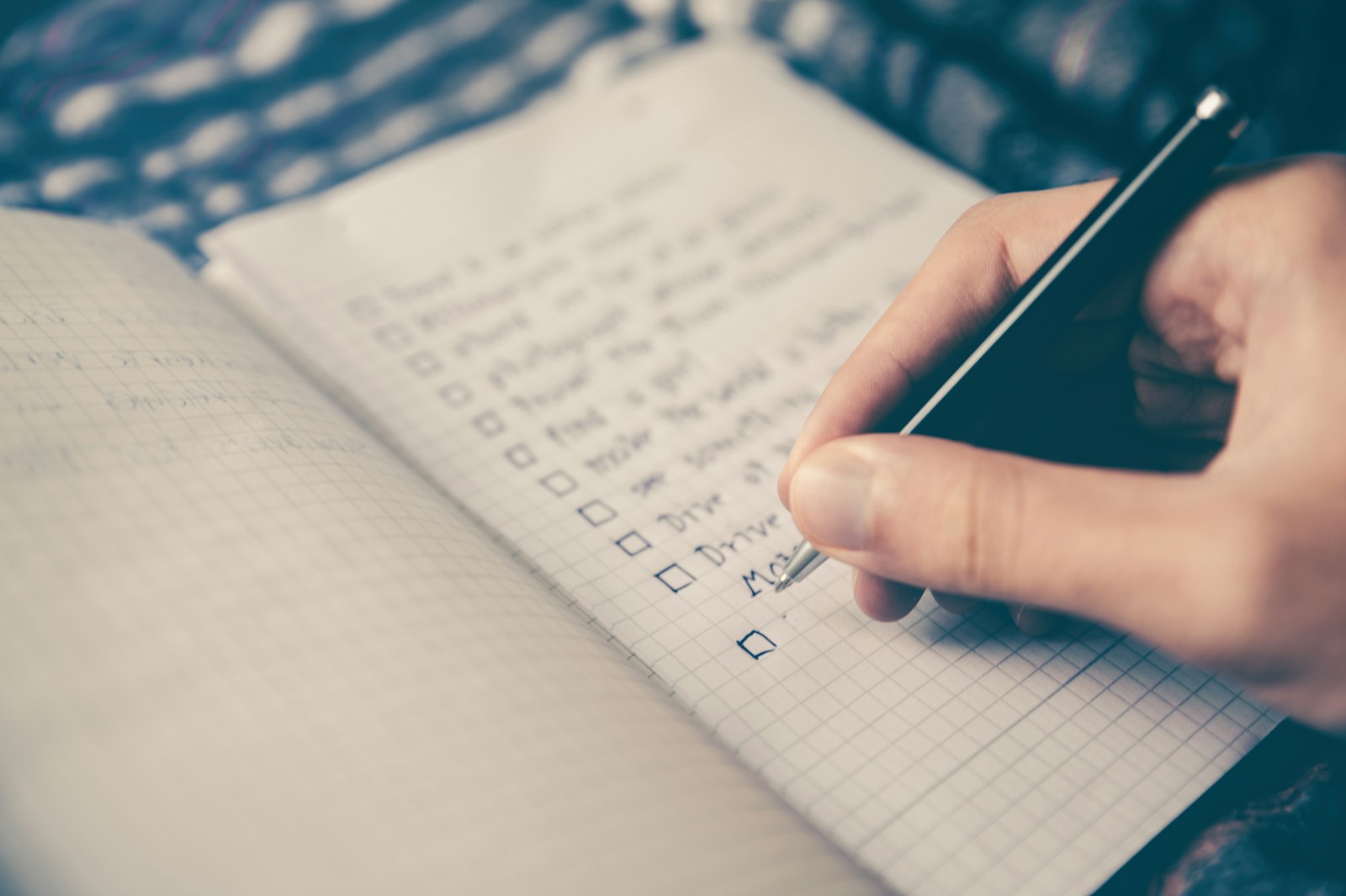 A handwritten checklist being ticked off with a pen